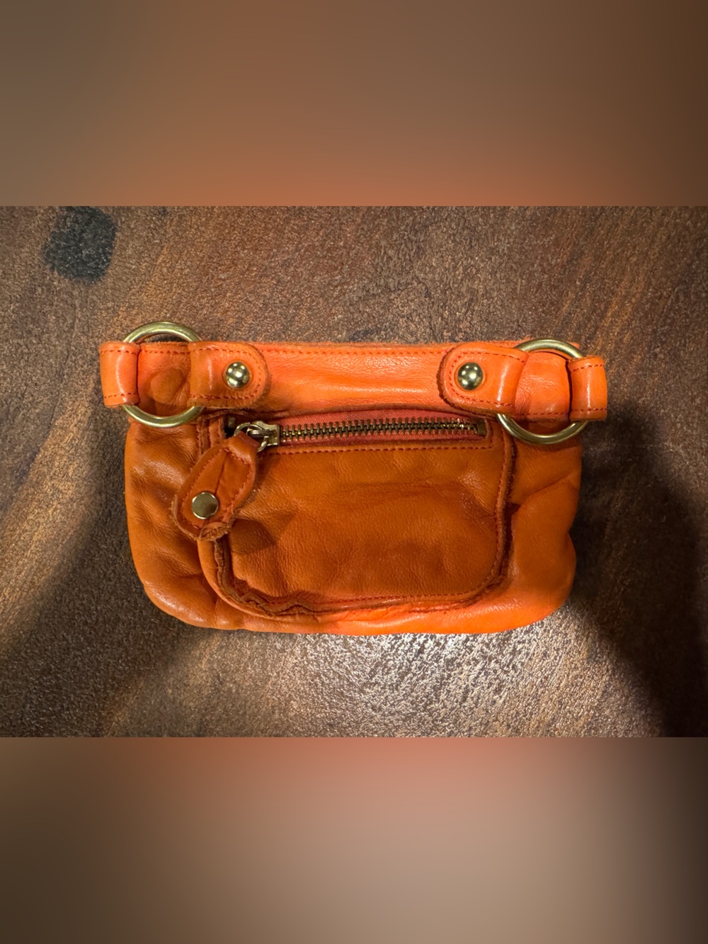 Orange leather clutch bag